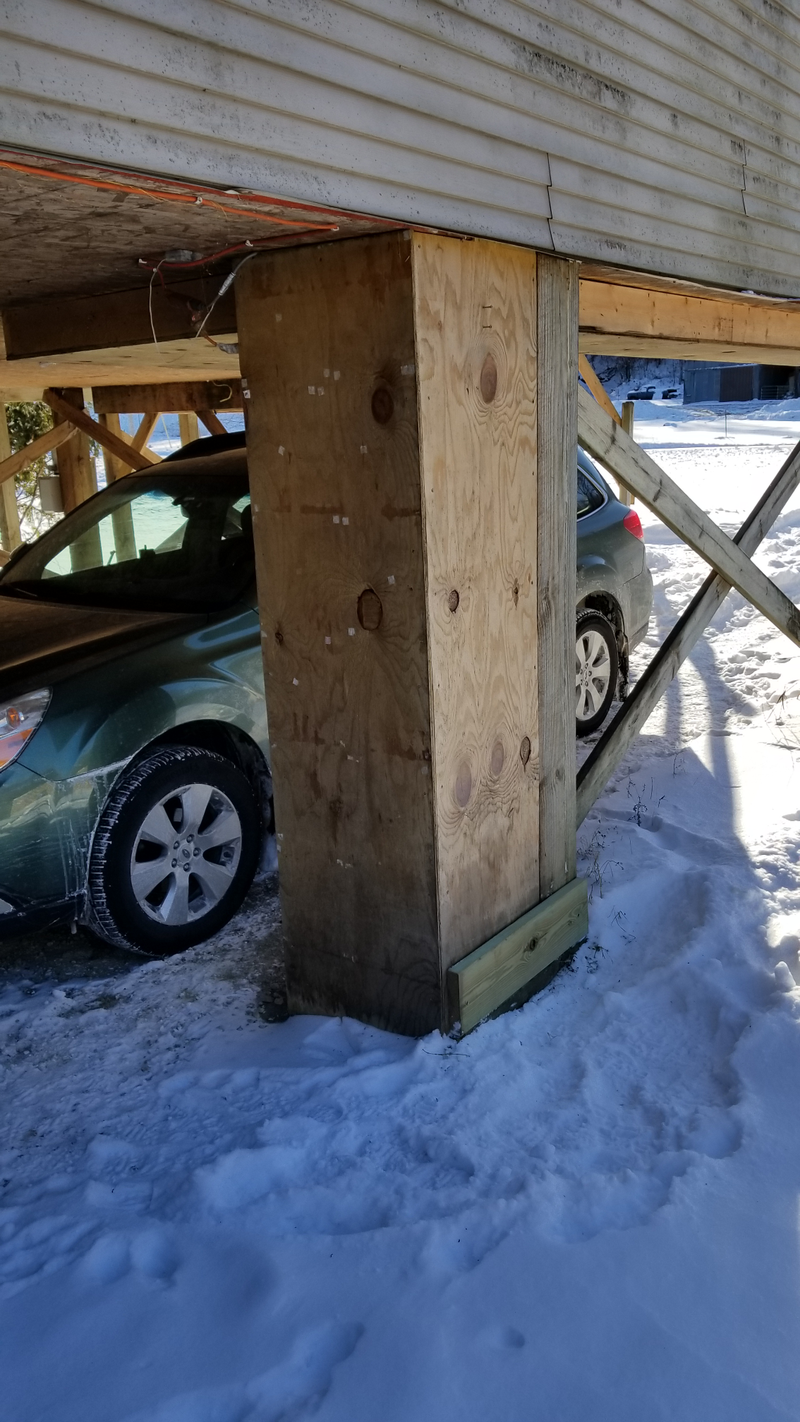 Behind the plywood is the water line and the septic line.